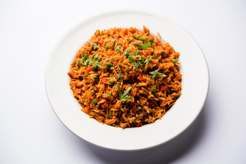 Schezwan Fried Rice Masala is a popular indo-chinese food served in a plate or bowl with chopsticks. selective focus