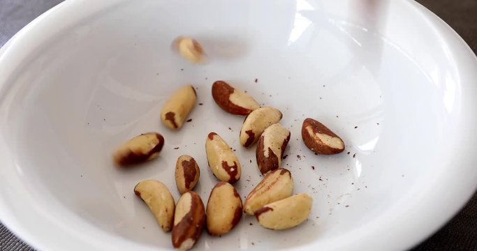 Brazil nuts pouring in a bowl