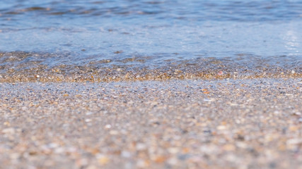 Fototapeta na wymiar Sand beach with small waves. Beautiful seascape.