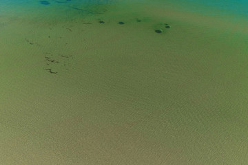 Aerial view of a green sea water, top view.