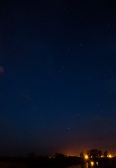  Night summer sky. City lights in the night. Blue starry sky. The lights are far away.