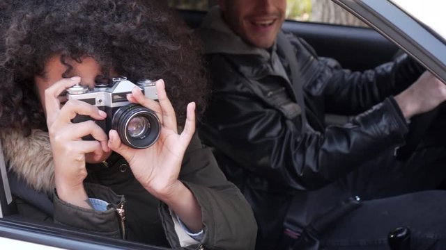 Couple photographing while sitting in car