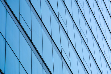 Fototapeta na wymiar pattern of modern glass windows building skyscrapers of business center in the city
