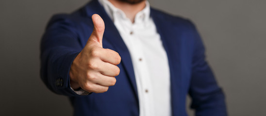 Unrecognizable businessman showing thumb up gesture panorama