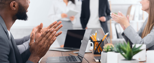 Business partners applauding to reporter after seminar