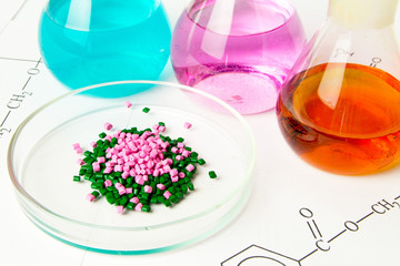 Plastic raw material in granules against the background of Chemical Laboratory and reagents....