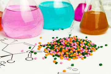 Plastic raw material in granules against the background of Chemical Laboratory and reagents....