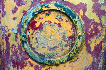 Fototapeta na wymiar Cracked colorful paint on a metal ornament