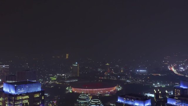 JAKARTA, Indonesia - December 17, 2018: Beautiful aerial landscape of night time in Jakarta business center with skyscrapers view and Senayan soccer field. Shot in 4k resolution
