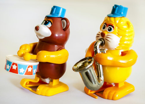 Bear, lion, drums and blowing  saxophone , marching band wind up toy / Isolated white