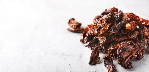 Dried slices of tomato on white background