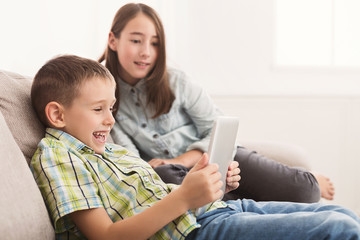 Little boy sharing funny content on digital tablet