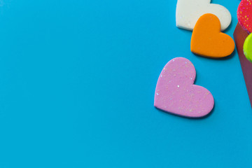 multi colour  heart on blue background close up image.