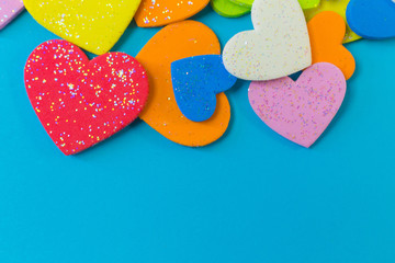 Obraz premium multi colour heart on blue background close up image.
