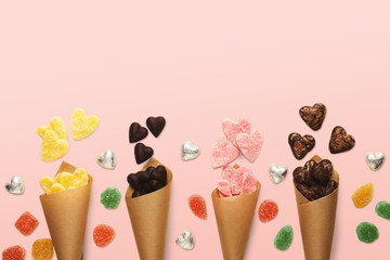 Lovers day background with various sweets in craft cornets