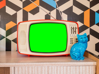 Retro television mock up with vintage wallpaper in the background. Template interior decoration with ceramic decoration from the 70s