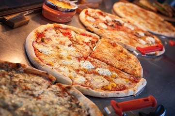 Slice of pizza quattro stagioni on scapula