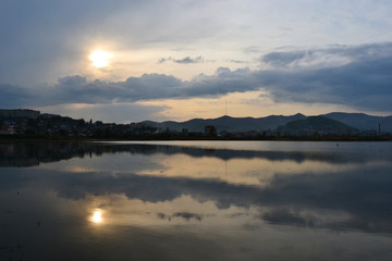sunset, reflection of the sun in the water of the lake