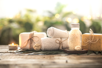 Spa handmade soap with white towels and sea salt, the composition of the tropical leaves with a...