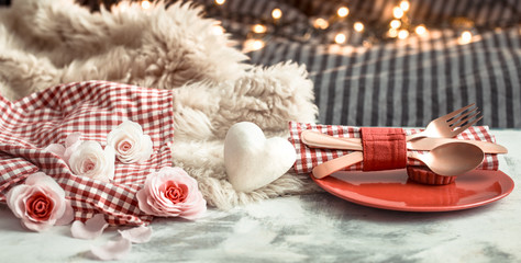 Obraz na płótnie Canvas Valentine's Day festive dinner on a wooden background cutlery