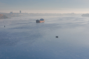 Cargo ship in fog on a river Dnieper