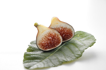 Fig fruits with leaves on white