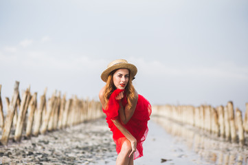 Beautiful red-haired young girl on the beach.