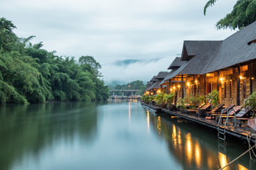 Resort wooden house floating and mountain fog on river kwai © Mumemories
