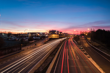 Fototapeta na wymiar Wake of lights on highway at dawn