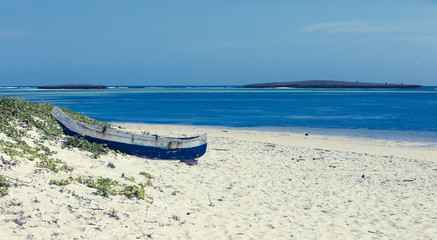 abandoned traditional aboriginal Malagasy wooden hand made fisherman dugout catamaran boat - canoe on the in Diego Suarez bay, Madagascar