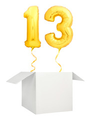Golden number thirteen inflatable balloon with golden ribbon flying out of blank white box isolated on white background