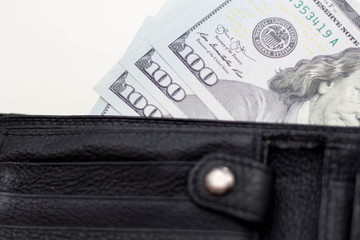 Dollar banknotes in leather wallet on white background