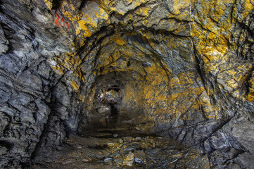 Golden rock in the old mine