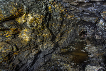 Golden rock in the old mine