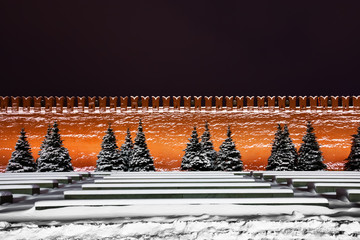 Moscow, the snow-covered Red Square, the Kremlin wall and the snow-covered spruce from it. stern and laconic view