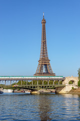 Metro crossing Bir-hakeim bridge with Eiffel Tower in background - Paris, France