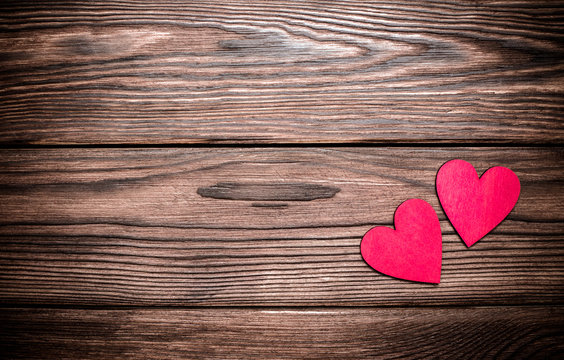 A symbol of love on brown wooden background 