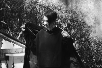 strong, laid back, cool girl, tomboy in black and white street style scene. Outdoor fashion images...