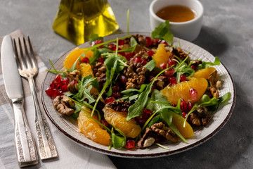 Arugula salad with oranges, walnuts and pomegranate.