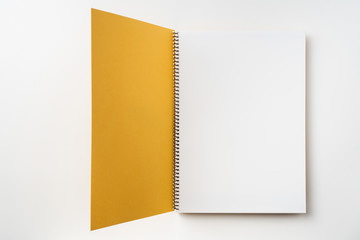 Top view of yellow spiral notebook with open page