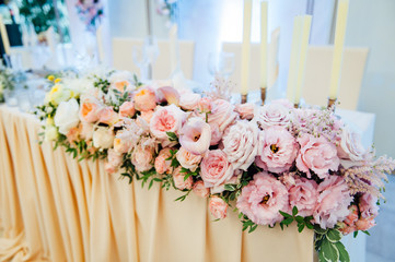 festive table for the bride and groom decorated with cloth and flowers