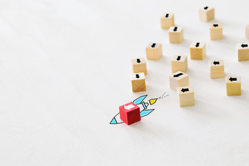 concept of think different, innovation and creativity. red cube changing direction from others.