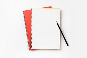 Top view of yellow and red spiral notebook