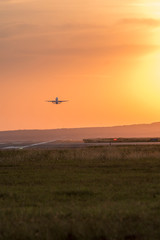 Take-off plane from the airport, shot at sunset.