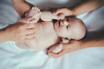 Newborn baby and family doctor. Doctor and newborn patient. Baby girl or boy given massage and body care. Family love and care. Visit to a baby doctor. Encircling your little one with quality care © Volodymyr