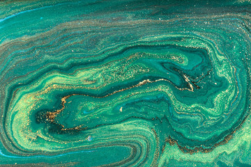 Gold marbling texture design. Green and golden marble pattern. Fluid art.