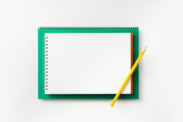 Top view of green and red spiral notebook