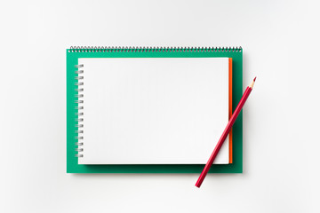 Top view of green and red spiral notebook