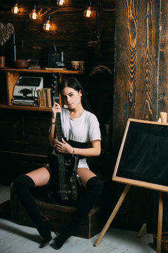 Like a rock star. Pretty woman with electric guitar. Sensual female guitarist. Rock style woman. Rock and roll music performer. Adorable music lover