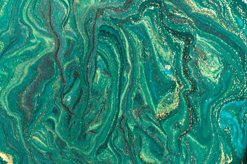 Gold marbling texture design. Green and golden marble pattern. Fluid art.
